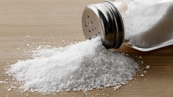 A salt shaker tipped over on a table