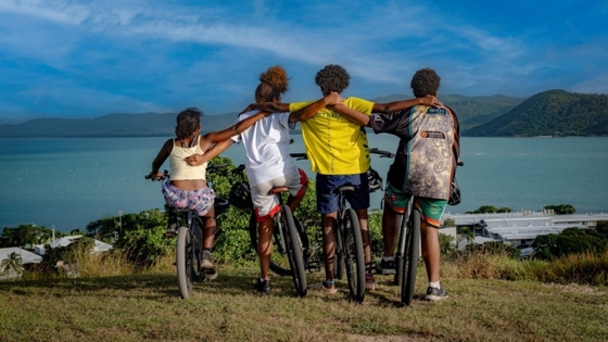 A group of young First Nations people cycling around Thursday Island.