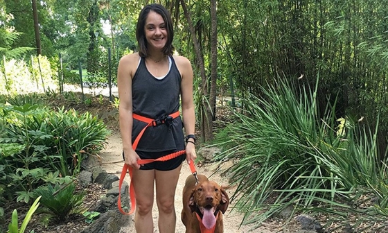 Alice walking her dog with a big smile