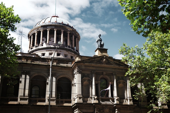 A majestic building with a towering clock, showcasing architectural grandeur.