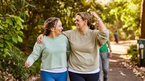 Two women walking through the park